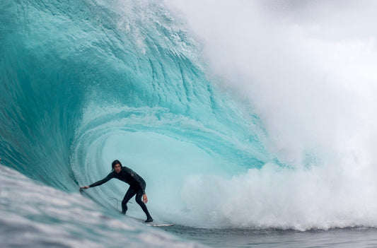 Surfer catching a wave, radiating energy and passion, fueled by the nutritious power of a Gone Bar.