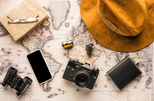 Travel essentials including a map, camera, and on-the-go snacks, ready for outdoor activities and capturing life's delicious adventures.