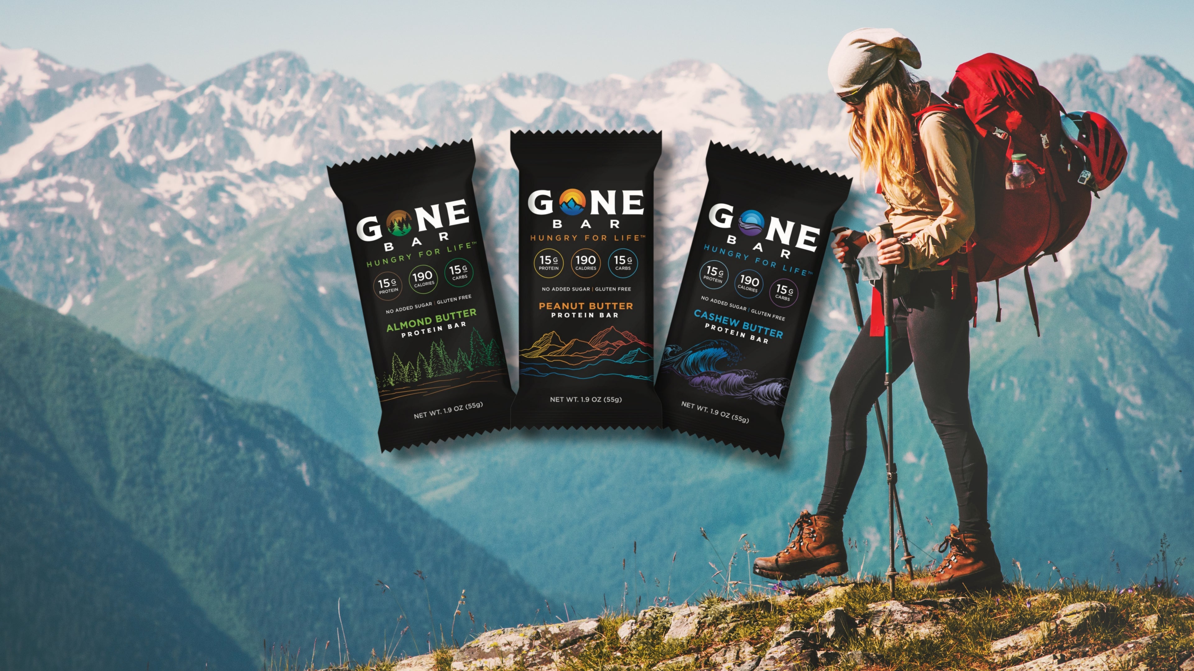 Hiker enjoying Gone Bar as a healthy snack on top of a mountain